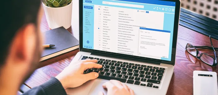 Someone working through a crowded email inbox on a laptop