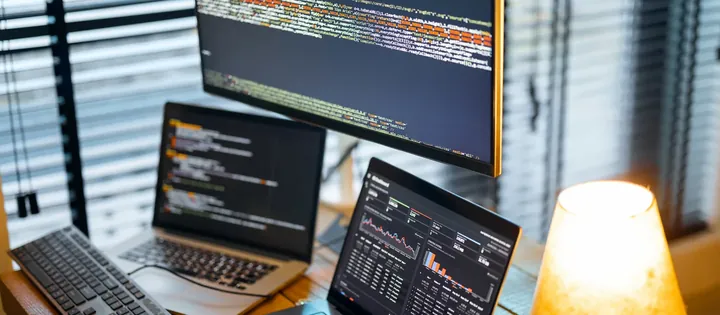 A developer workstation showing code and a live dashboard
